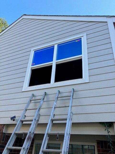 A ladder is leaning against the side of a house