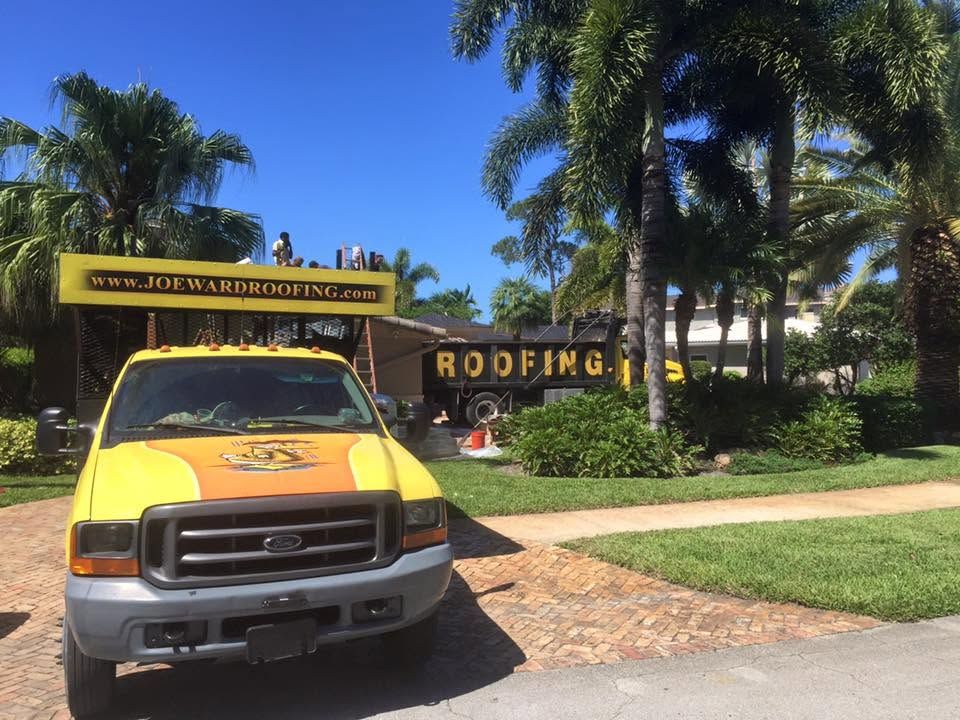 Licensed Joe Ward Roofing crew and company truck on a residential roof replacement job in Palm Beach