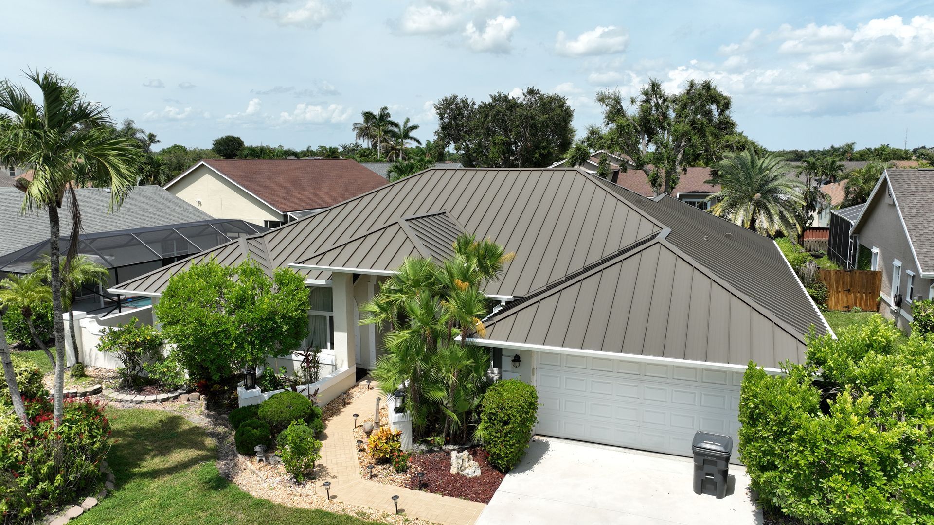 Aerial view of Wellington Florida home featuring Englert 24‑gauge Medium Bronze mechanical standing 
