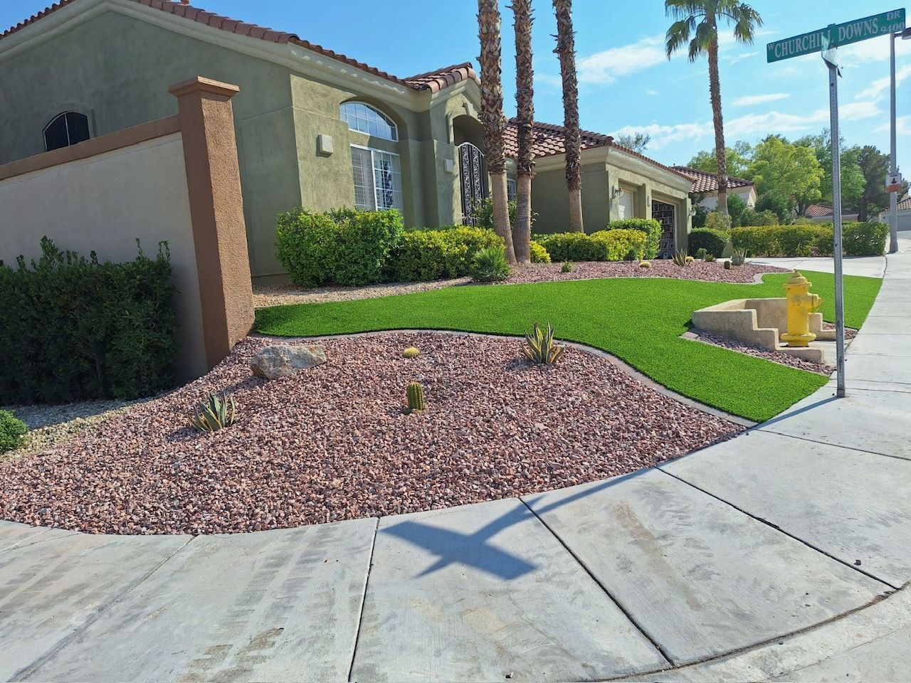 A house with a lush green lawn in front of it.