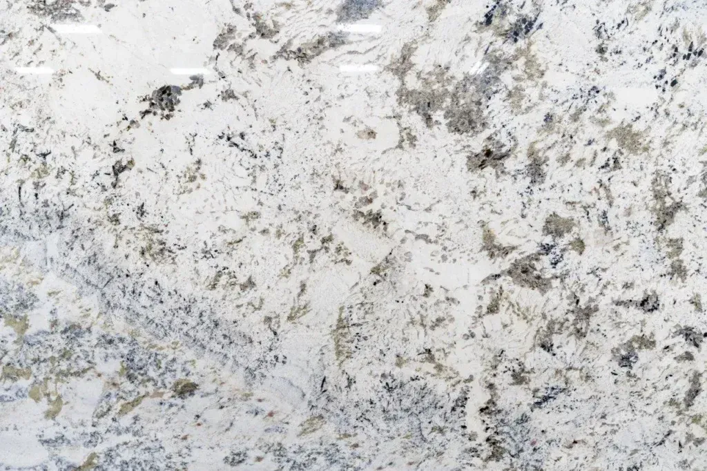 Close-up of a white and gray speckled marble-like stone surface with a rough texture