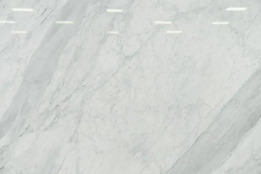 Light gray marble surface with subtle veining and faint white markings near the top