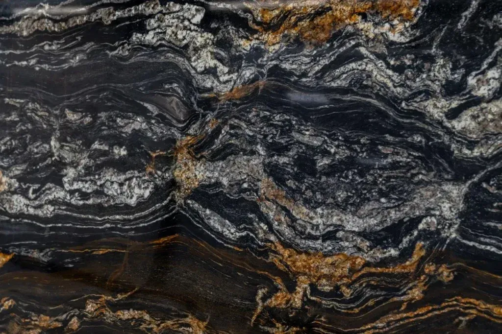 Dark, marbled stone texture with swirling gray, black, and rust-colored bands