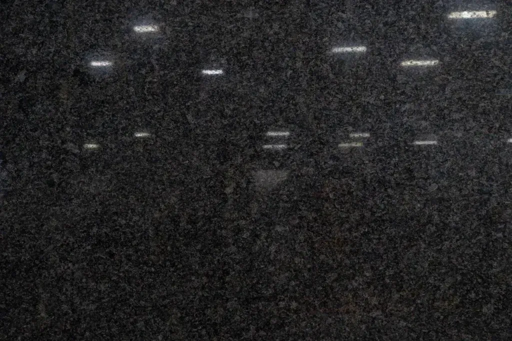 Dark grainy view of several small white lights in rows against a black background