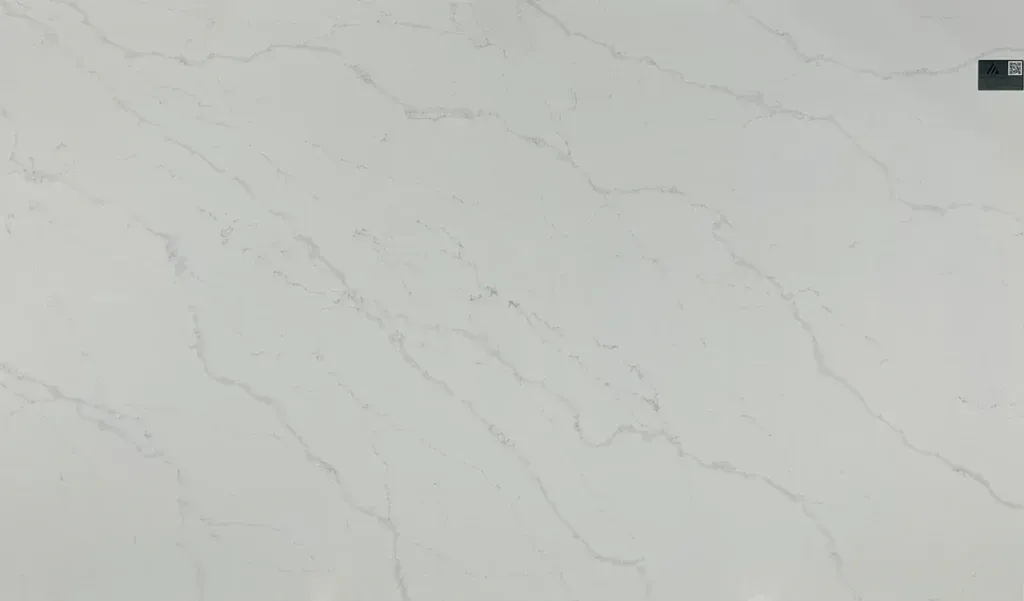 Light gray marble countertop with subtle veining and a small dark object in the top-right corner