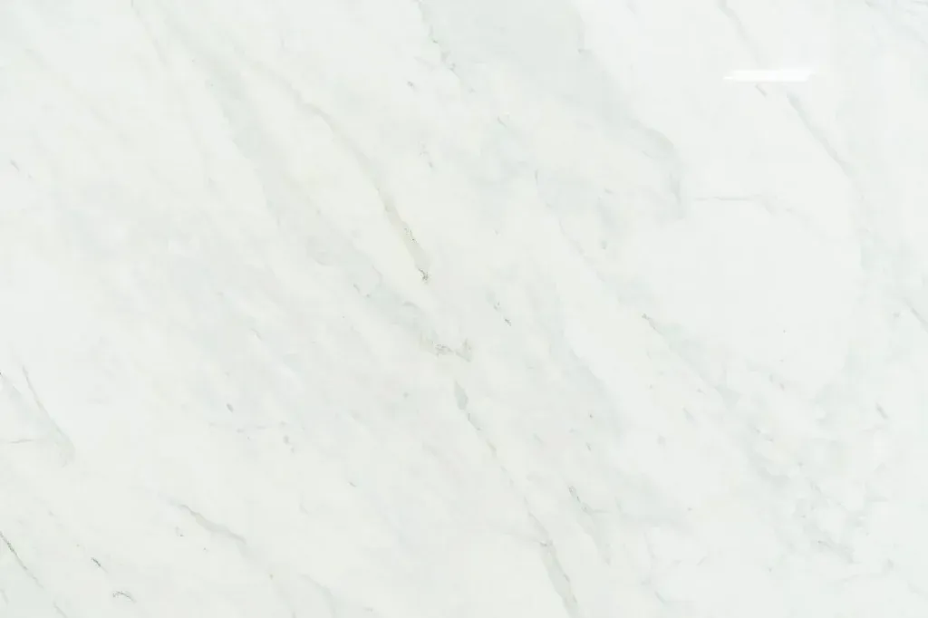 White marble-like stone surface with subtle gray veining