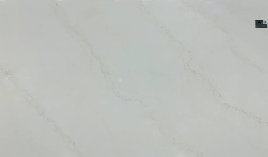 Light gray marble wall with subtle veining and a small dark square in the upper right corner