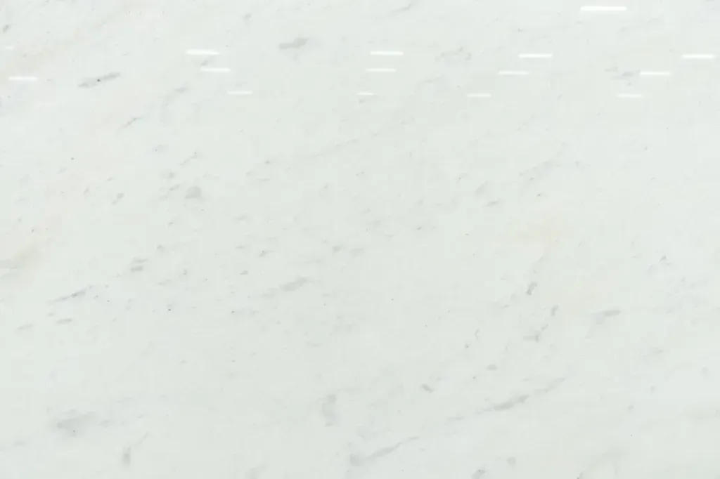 Light gray speckled surface with faint scattered marks