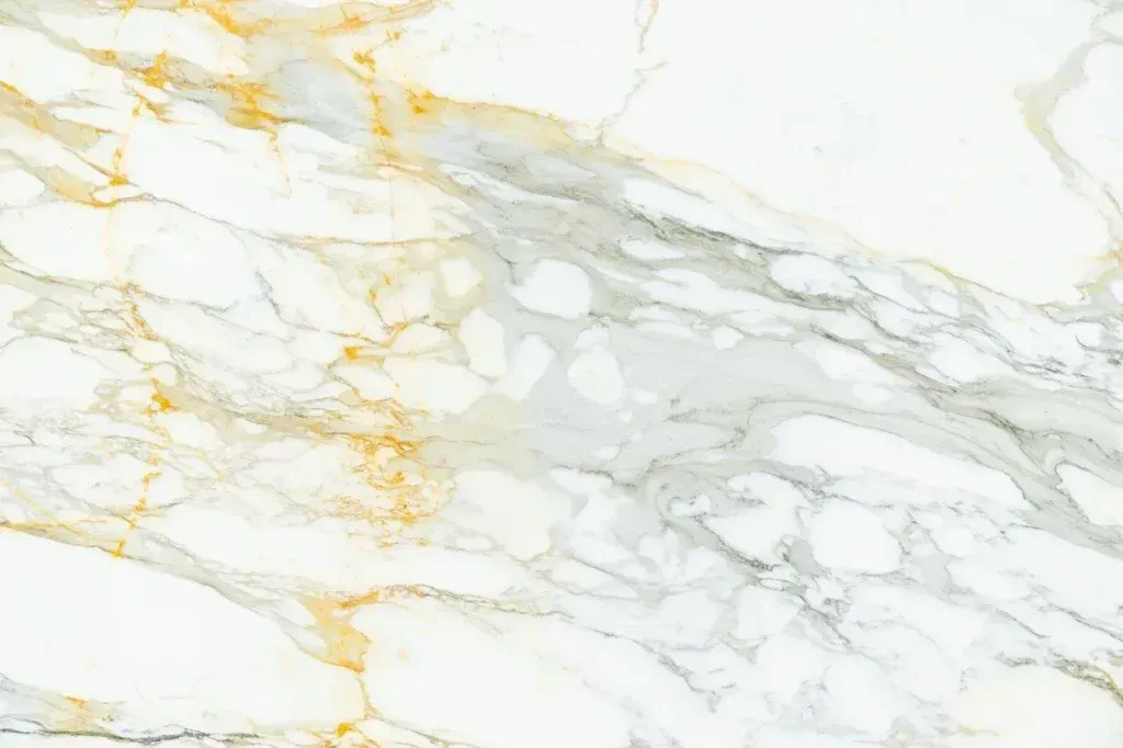 White marble texture with soft gray veining and gold streaks