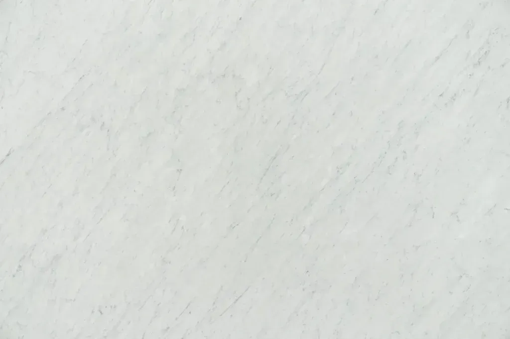 Light gray textured surface with faint diagonal streaks