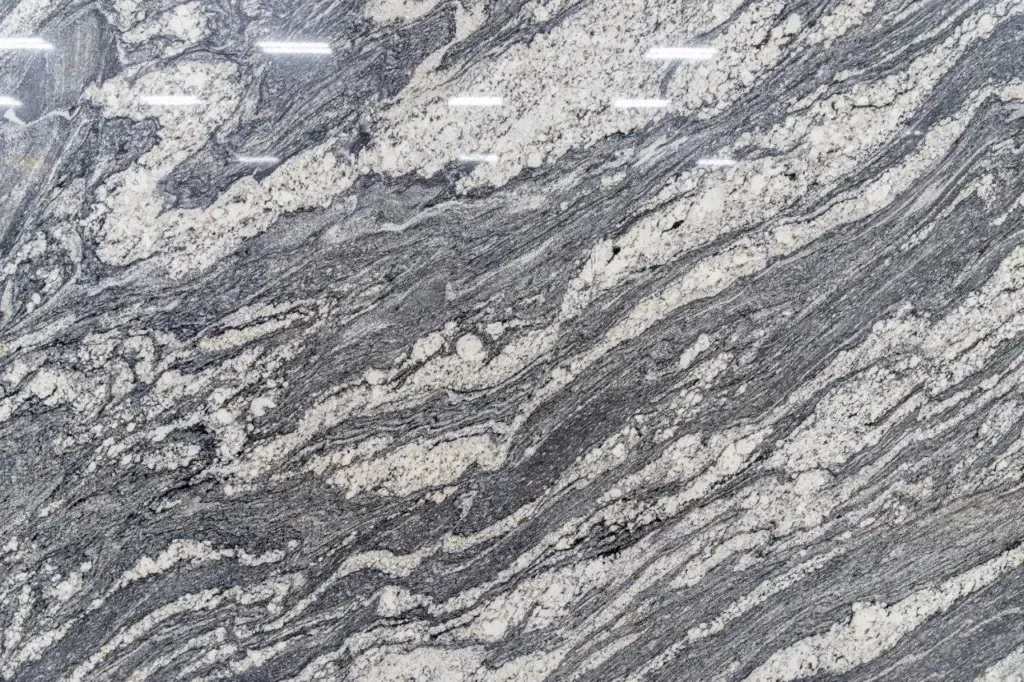 Gray and white marbled stone with wavy streaks and textured pattern