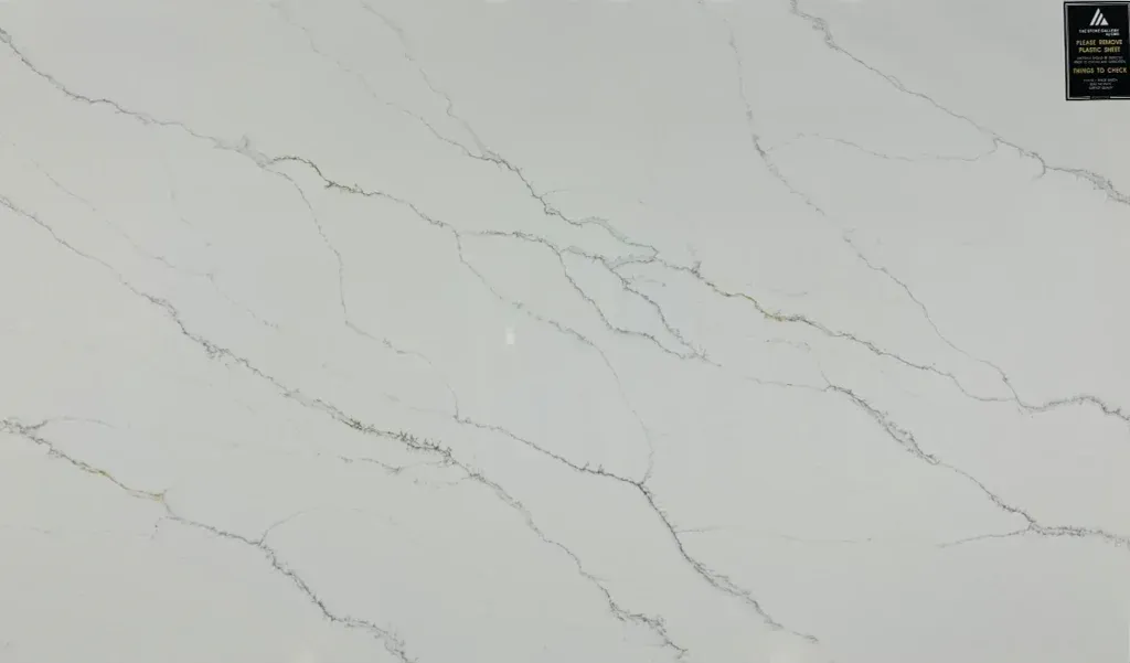 White marble-like surface with thin gray veining and a small label in the top-right corner