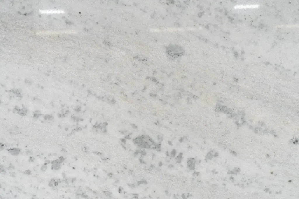 Light gray speckled stone or marble surface with subtle dark veining