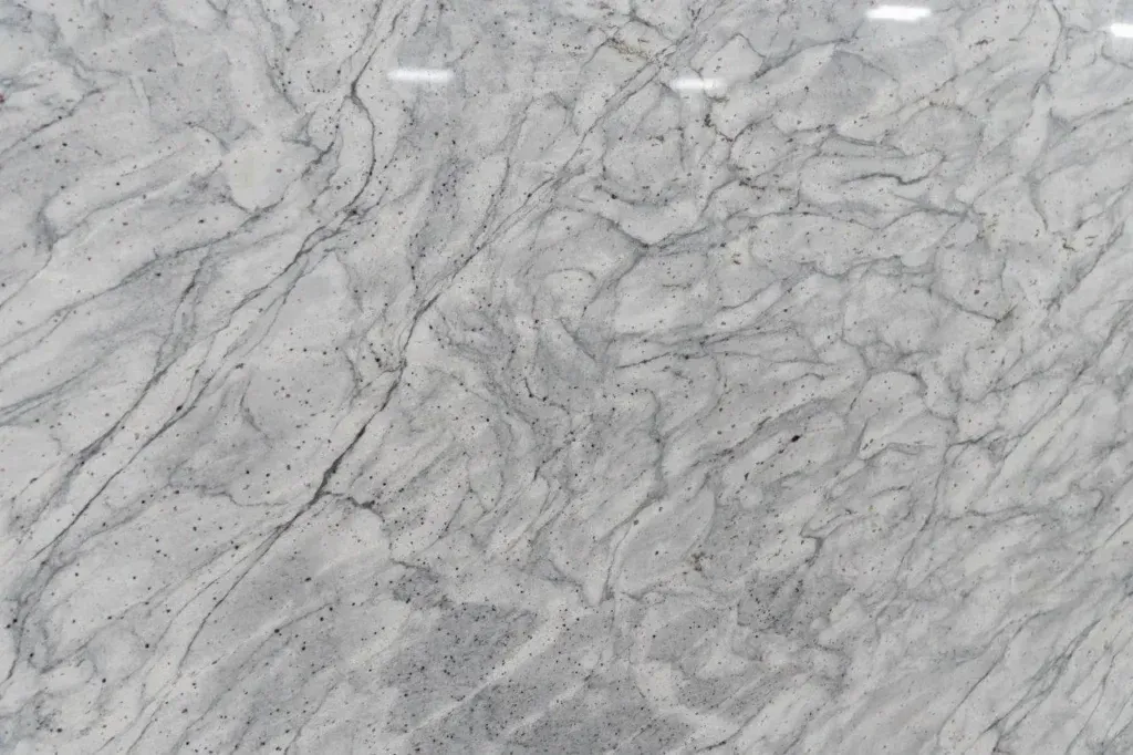 Light gray marble surface with dark veining and speckled texture