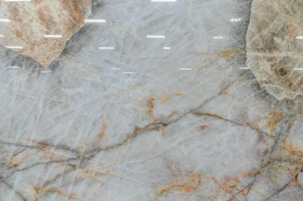 Gray marble surface with white and tan veining and fuzzy beige edges
