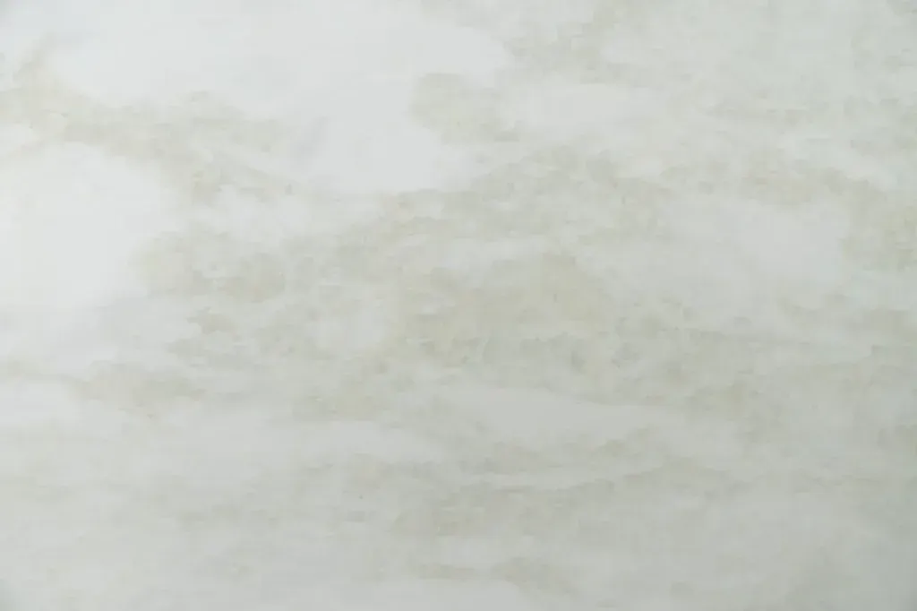 Light gray marble or stone surface with faint veining and a subtle cloudy texture