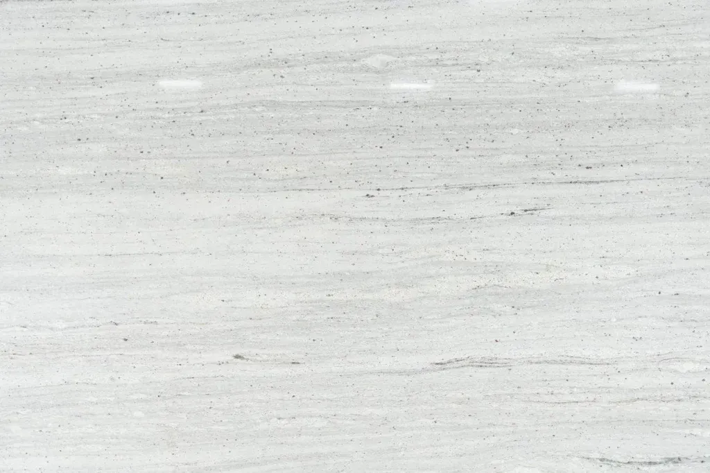 Close-up of a light gray, textured surface with subtle horizontal streaks