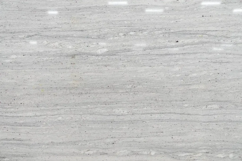 Gray, snowy textured surface with faint horizontal streaks and small white highlights