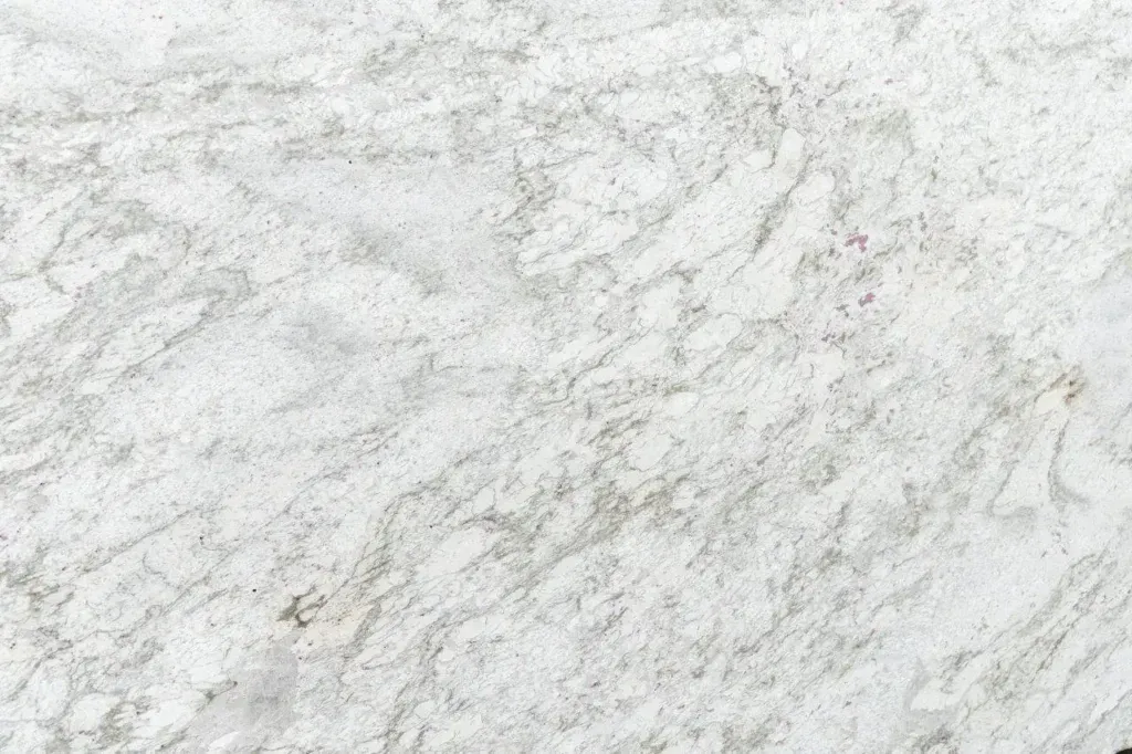 White marbled stone surface with subtle gray veining and texture