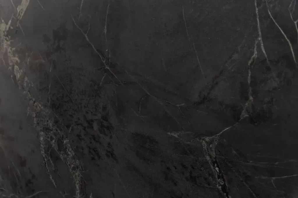 Dark black marble surface with subtle gray veining.