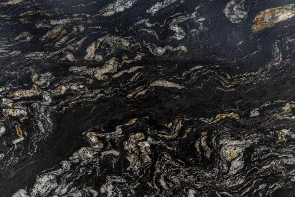 Dark marbled stone with swirling black, gray, and white veins