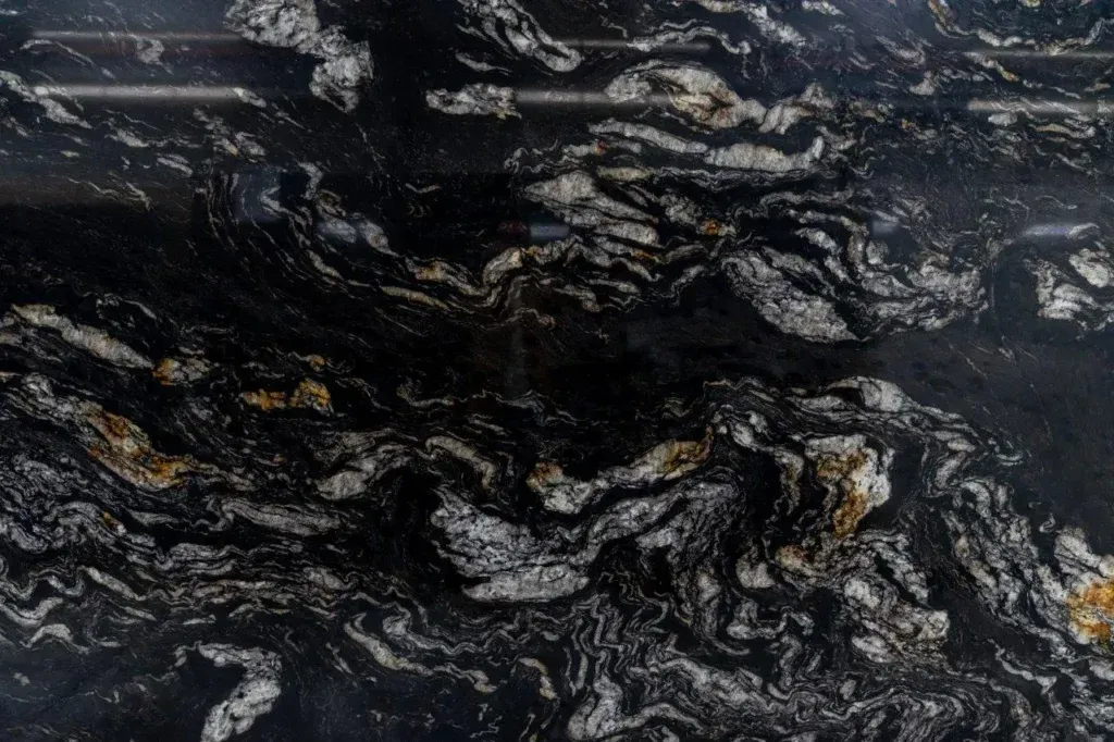Dark, swirling cloud formations over a deep blue surface, resembling a stormy ocean or Earth from space
