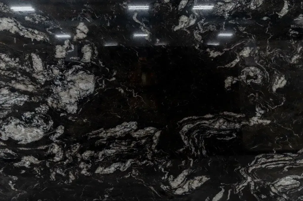 Dark black marble slab with white veining and glossy reflections