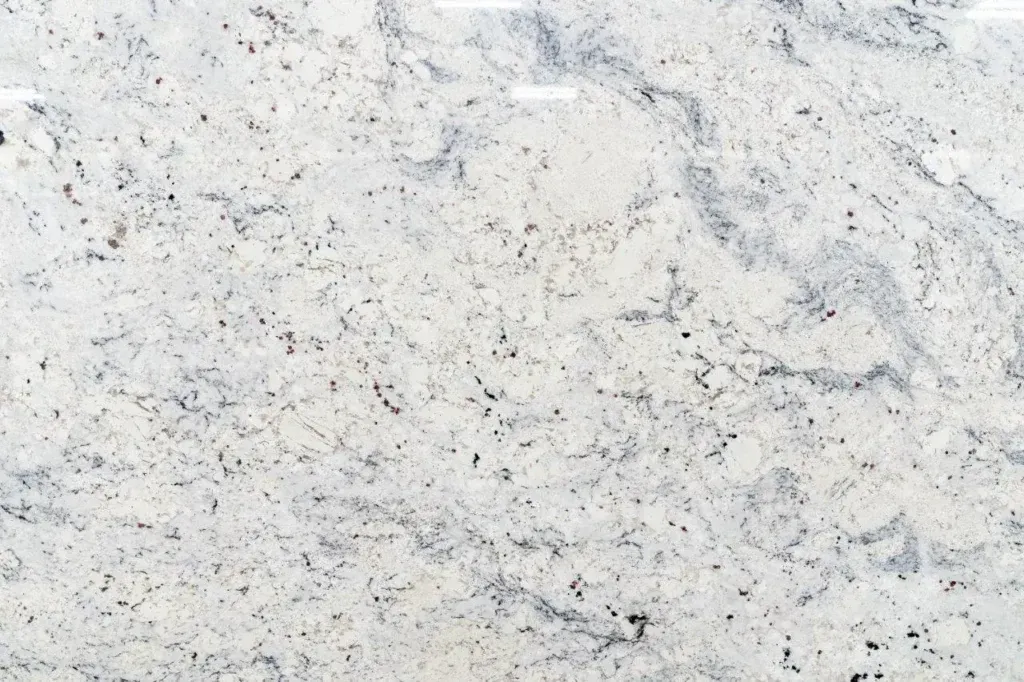 White speckled stone or marble surface with gray veining