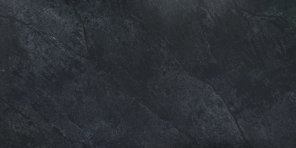 Dark gray textured surface with subtle diagonal streaks