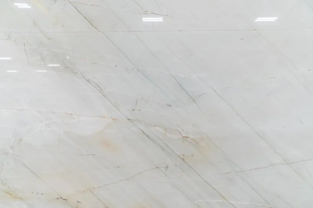 Light gray marble surface with subtle diagonal veins and faint beige streaks
