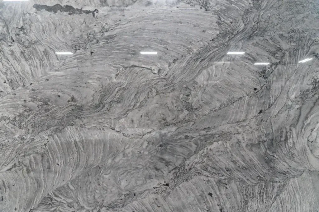 Gray marble countertop surface with white veining and polished reflections