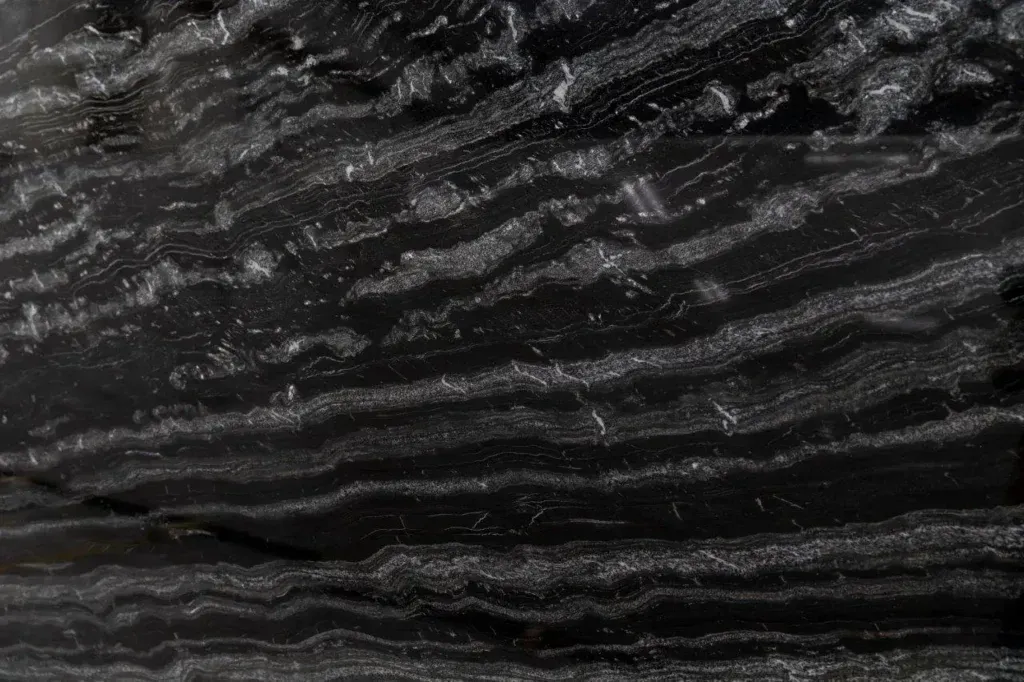 Dark textured surface with wavy black and gray striations