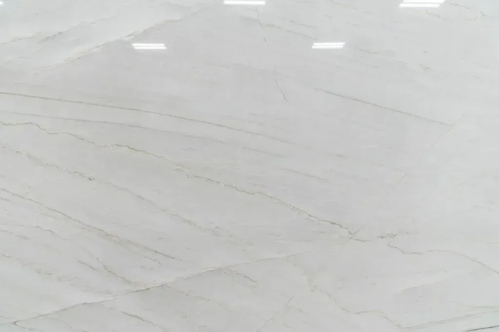 Light gray tiled floor with faint diagonal seams and bright reflections at the top