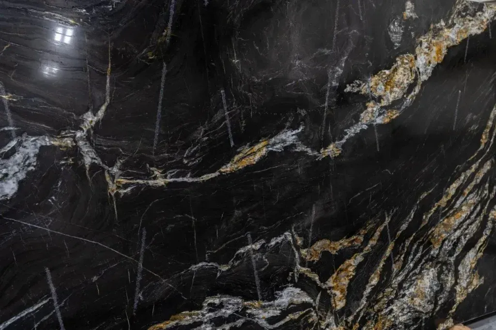Dark polished marble surface with white and gold veining