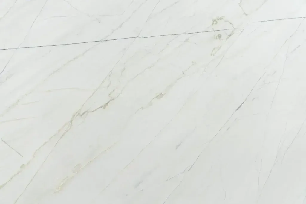 White marble surface with faint gray veining and subtle gold streaks