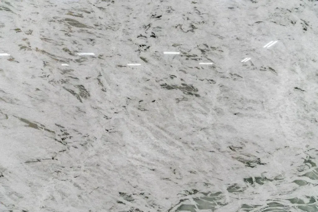 White and gray marbled stone surface with subtle green veining