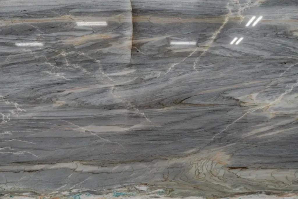 Gray marble slab with wavy white veining and polished reflections