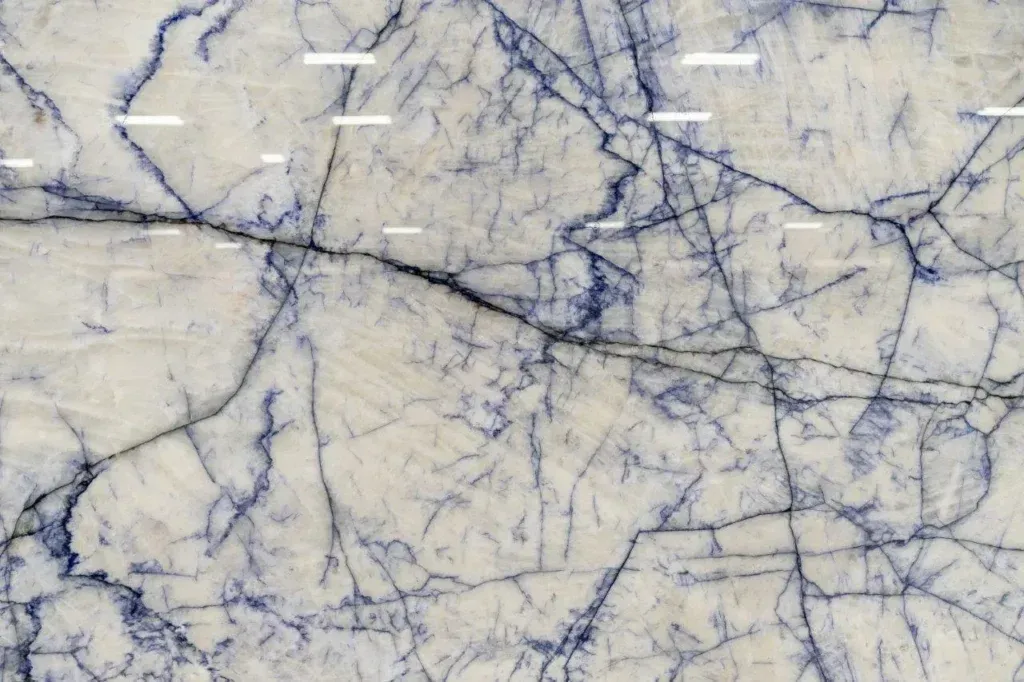 White marble texture with thin blue-gray veins crisscrossing throughout.