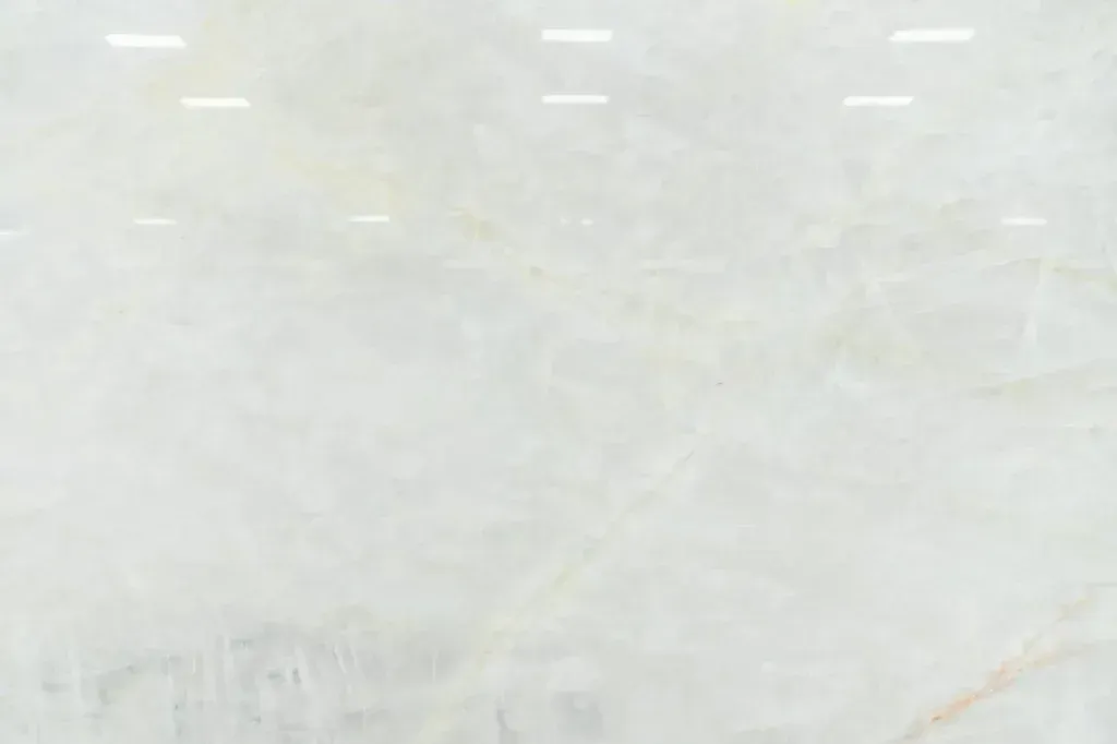 Light gray, mostly blank surface with faint horizontal marks and subtle stains