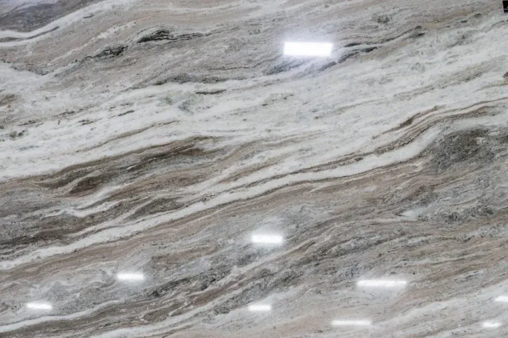 Gray and white veined stone surface with polished reflections