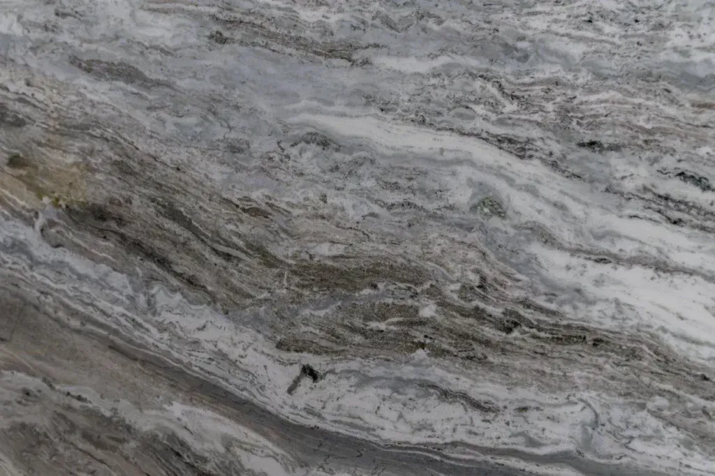 Gray and white marbled stone surface with flowing layered veins