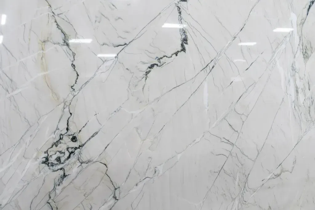White marble surface with gray veining and subtle gold streaks