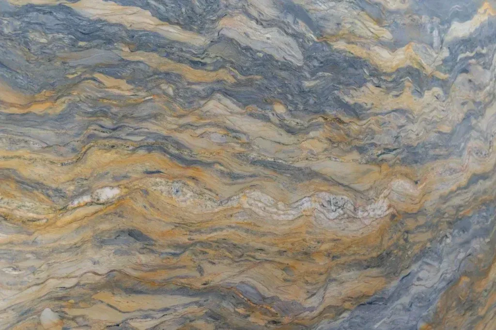 Close-up of layered beige, gray, and blue stone with wavy veining pattern