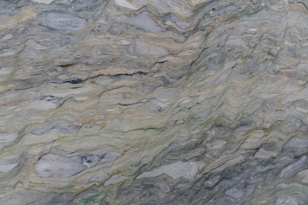Gray and beige wavy stone texture with layered, marbled patterns