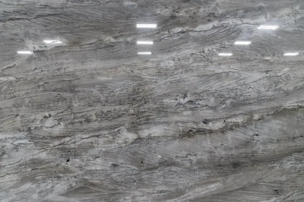 Gray marble stone surface with subtle veining and glossy reflections