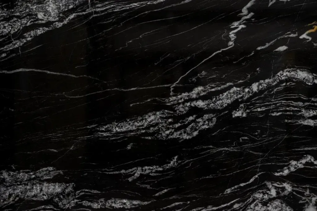 Dark black marble texture with white veining and streaks