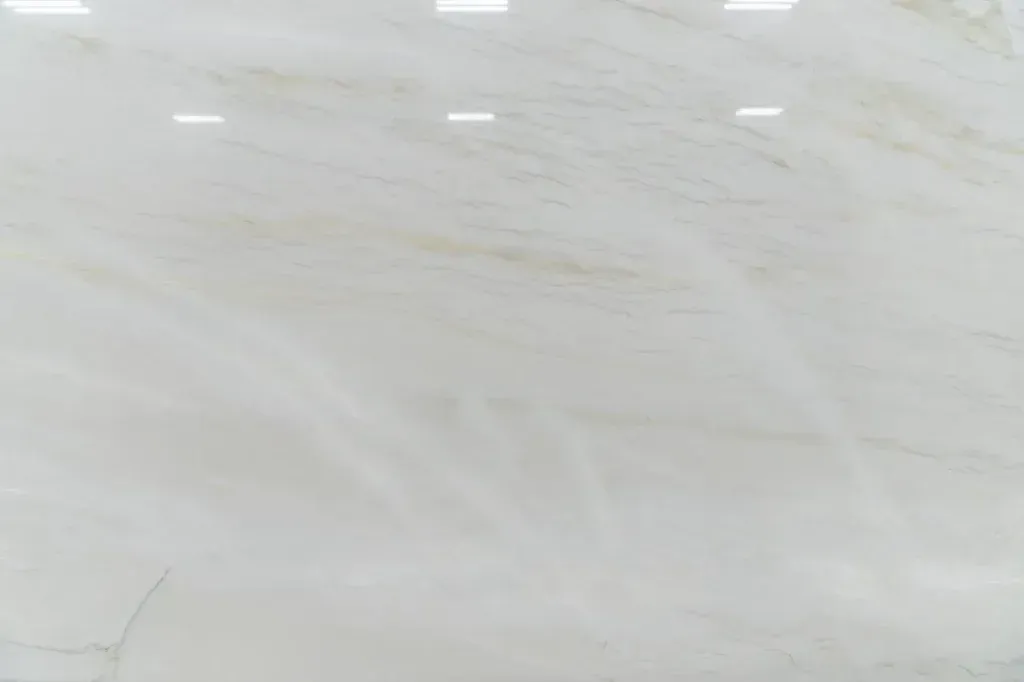 White tiled floor with faint gray veining and a few small white marks near the top edge