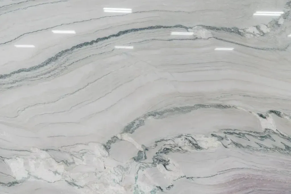 White and gray marble-patterned stone with flowing veining and glossy surface