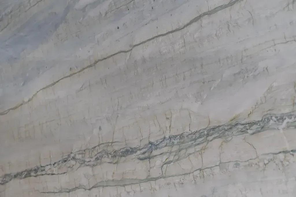 Light gray marble surface with faint horizontal veins and a darker diagonal crack line