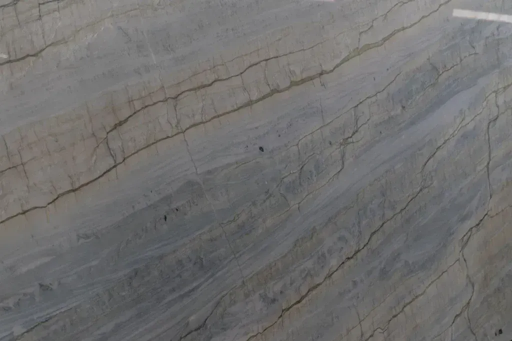 Gray stone surface with subtle wavy veins and layered textures